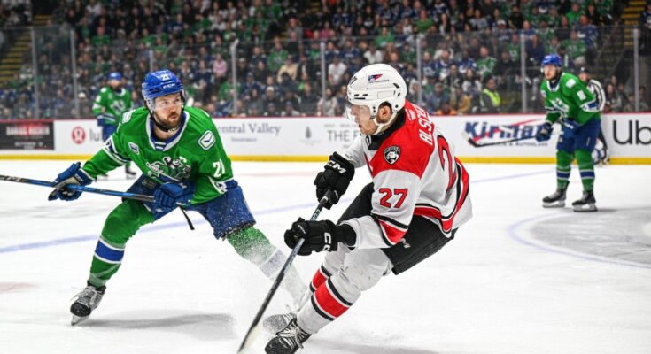 Az Abbotsford Canucks Chase Wouters (21) kapitánya nagy sikert arat, Charlotte Marek Alscher hölgyek védelmezőjében. (Fotó jóváírás: @ AbbyCanucks / X)
